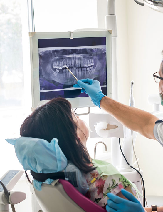 dentist showing dental xray to patient
